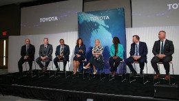 group presenting on stage at kickoff event