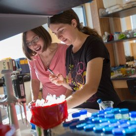 teacher and student working in science lab