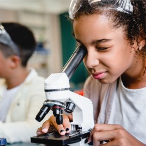 girls looking in microscope